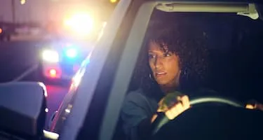 Woman driver getting pulled over by police at night