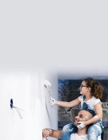 Parent and child painting a wall in their home