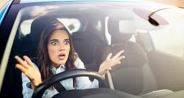 A woman is frustrated as she sits in traffic