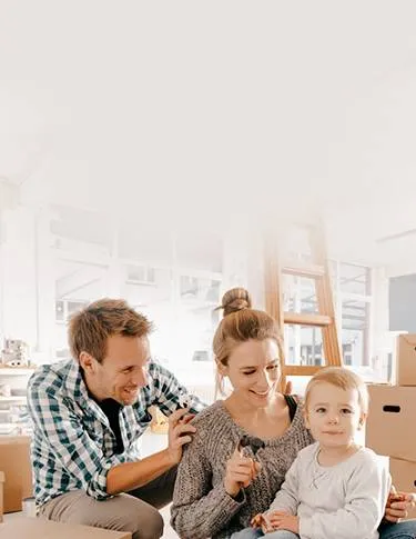 Parents playing with baby in new home