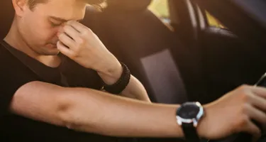 Fatigued man struggling to drive