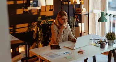 woman checking computer at desk