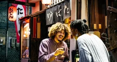 A couple laughing and enjoying a meal together in Japan