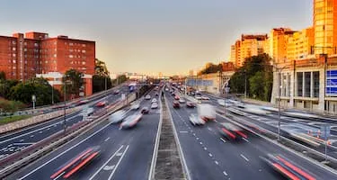 Cars driving on busy Sydney road at sunset