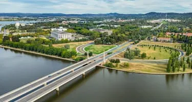 Cars cross the Commonwealth Avenue Bridge over Lake Burley Griffin driving into Canberra, Australian Capital Territory.