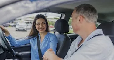 Young woman smiles after passing driving test