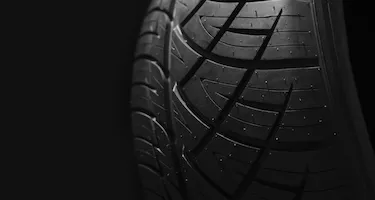 A close up of a car tyre tread with pattern