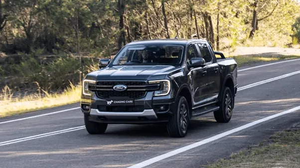 grey ford ranger driving down road outside