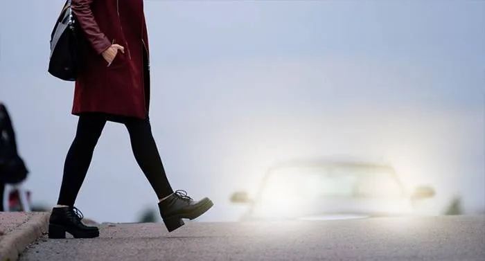 Woman walking into oncoming traffic