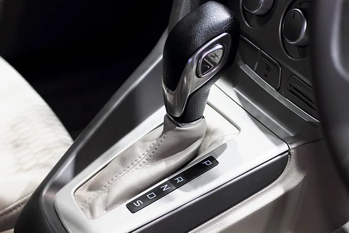 White letters are displayed along an automatic gear selector when drivers need to switch gear positions.