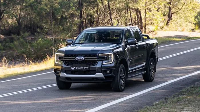 grey ford ranger sport driving down road outside