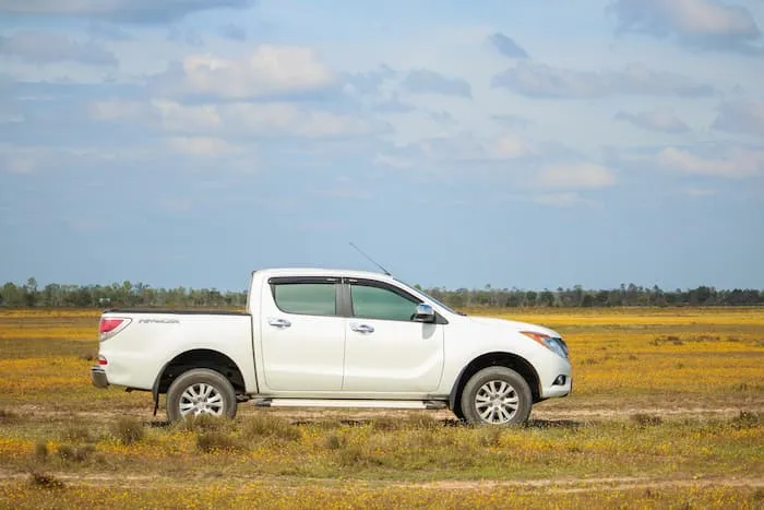 White Mazda BT-50 parked on grass