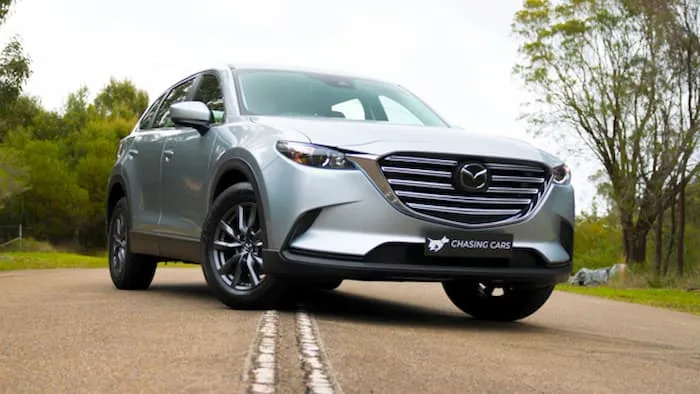 Silver Mazda CX-9 Sport parked in the middle of the road