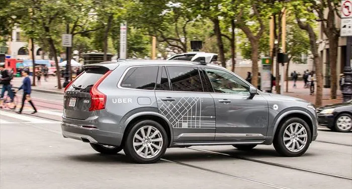 Driverless Uber car going across an intersection