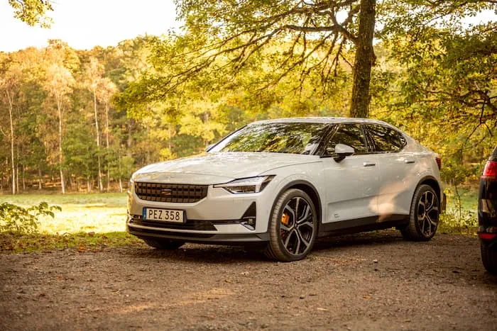 White Polestar 2 parked on dirt outside