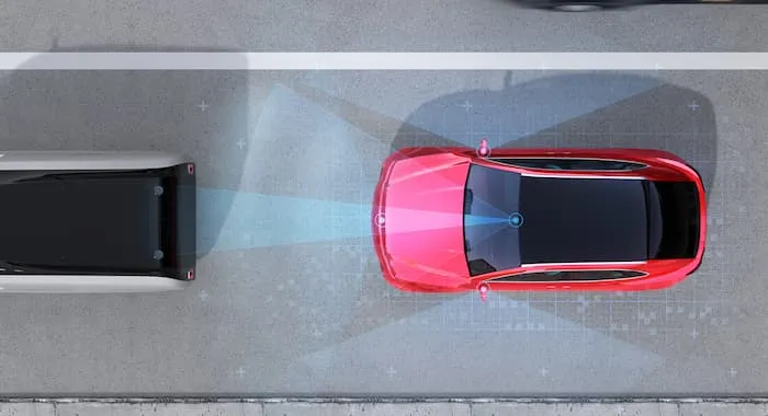 An aerial view of a car and its sensors avoiding a collison