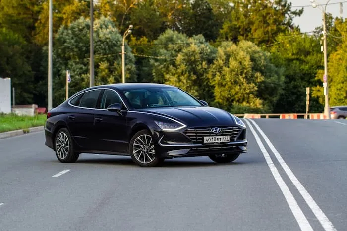 black Hyundai Sonata parked on the road outside