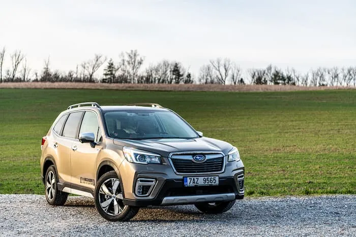 Grey Subaru Forester parked on gravel road outside