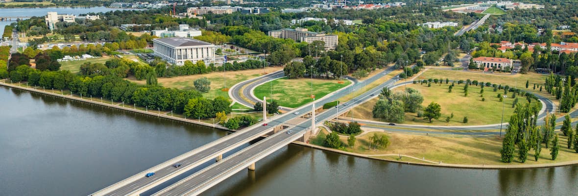 Cars cross the Commonwealth Avenue Bridge over Lake Burley Griffin driving into Canberra, Australian Capital Territory.