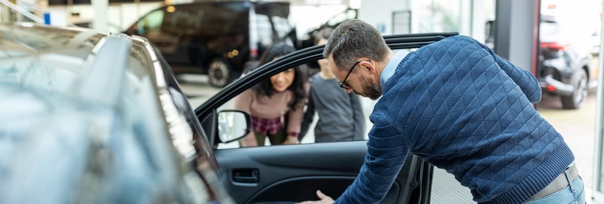 man checks interior of car before buying