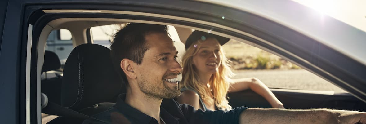 Smiling young couple drives in rural Australia