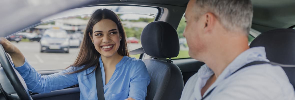 Young woman smiles after passing driving test 