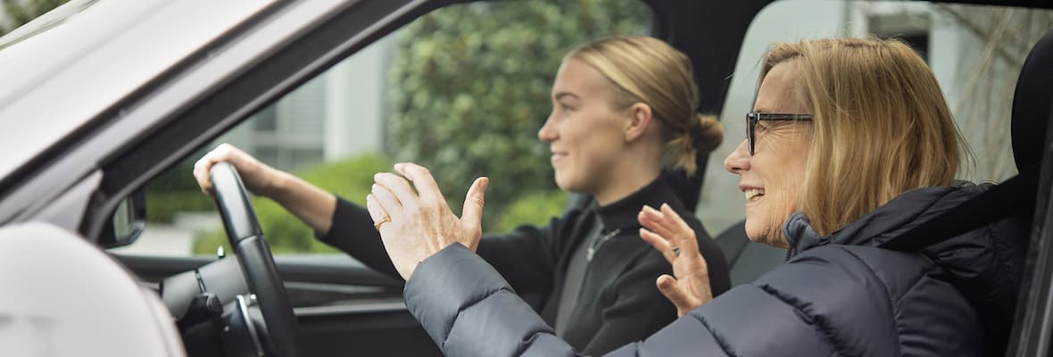 Older woman supervising learner driver