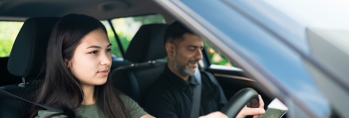 Woman driving a man in the passenger seat