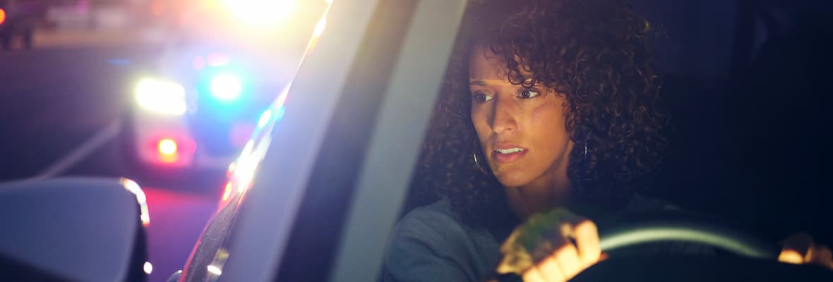 Woman driver getting pulled over by police at night