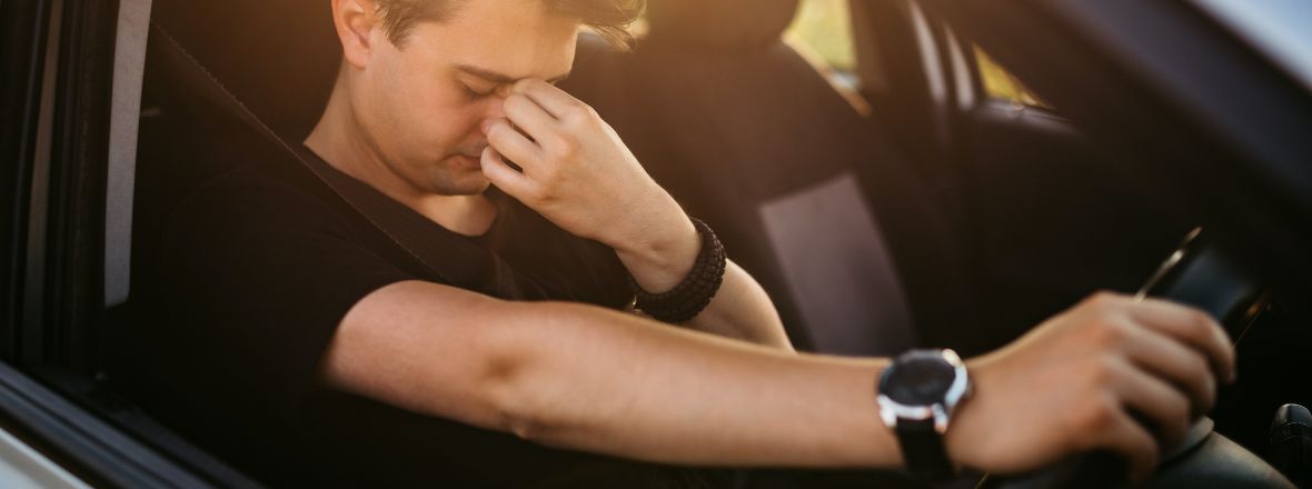 Fatigued man struggling to drive