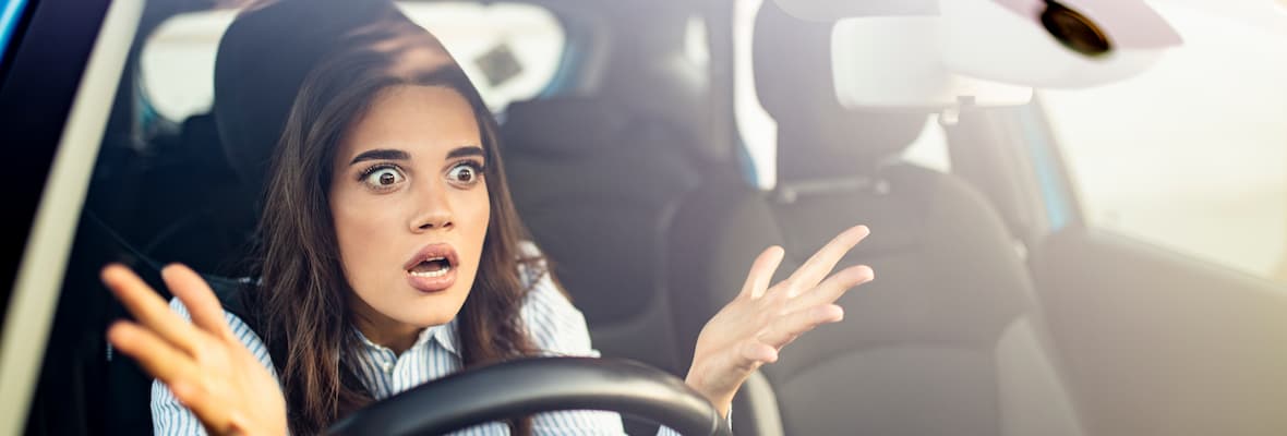 A woman is frustrated as she sits in traffic