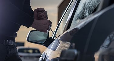 Person breaking into a car