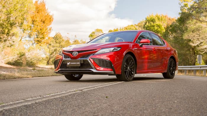 Red toyota Camry parked on the road