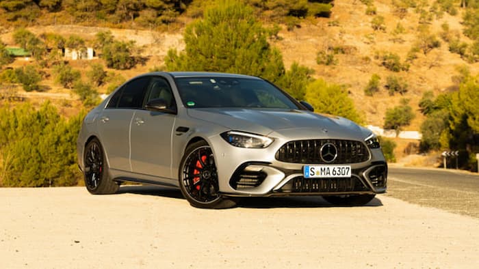 grey mercedes-benz c class parked on gravel