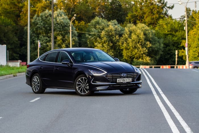 black Hyundai Sonata parked on the road outside