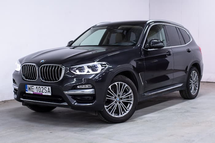 Black BMW X3 xDrive30 parked inside on concrete