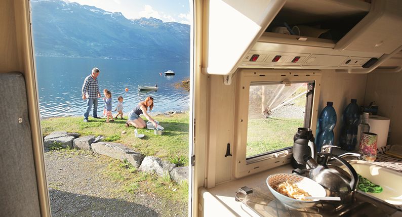 Family enjoying caravan lifestyle beside a lake