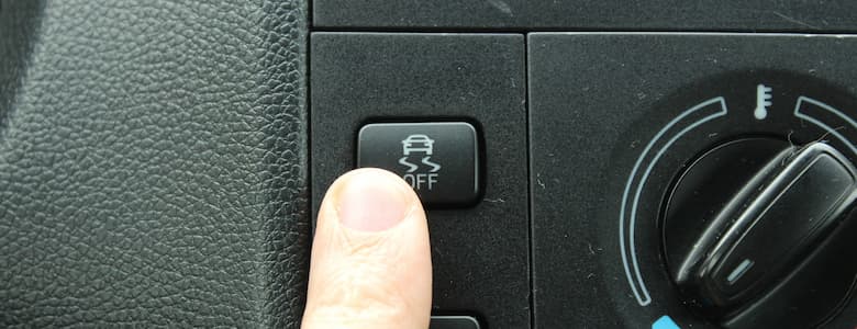 Pressing the Electronic Stability Control button in a car