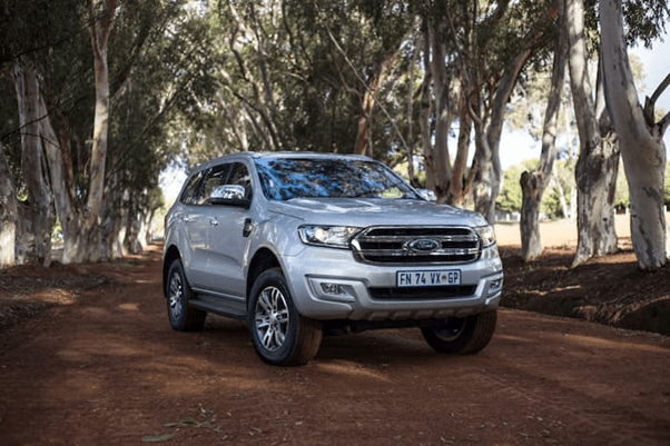Silver Ford Everest parked on dirt track outside
