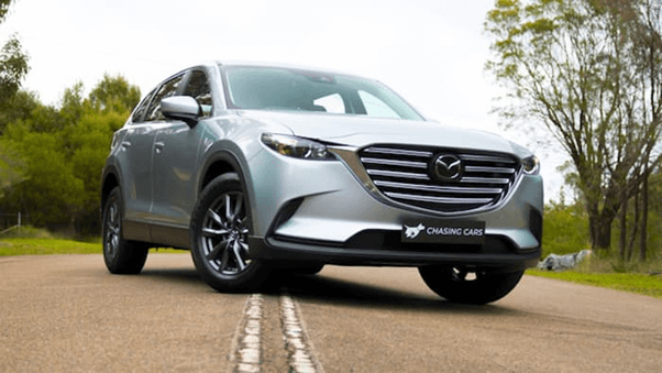Silver Mazda CX-9 Sport parked in the middle of the road