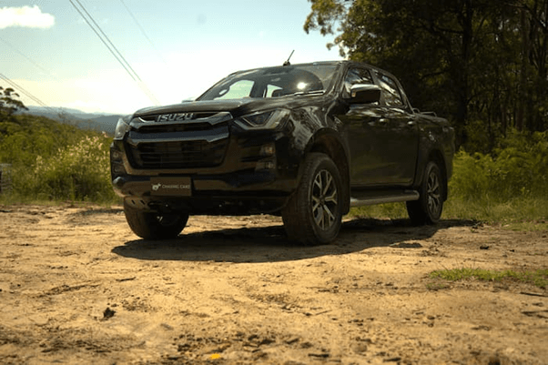 Black Isuzu D-Max parked on gravel outside