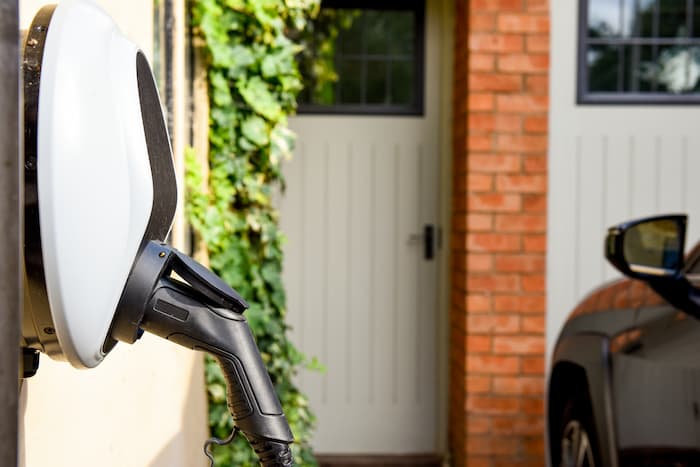 A wall-mounted car charging unit provides power to electric vehicles at home