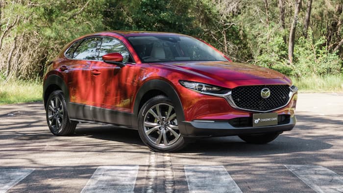 red Mazda CX-30 parked on road outside