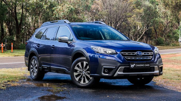 blue Subaru Outback parked on road outside