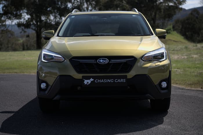 gold subaru xv parked on gravel road