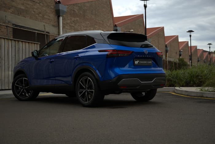 blue Nissan Qashqai parked in parking lot