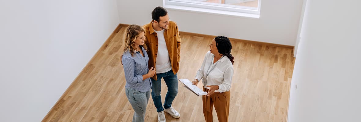 Real estate agent shows young couple an apartment