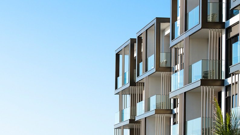 Modern apartments against a backdrop of a clear, blue sky