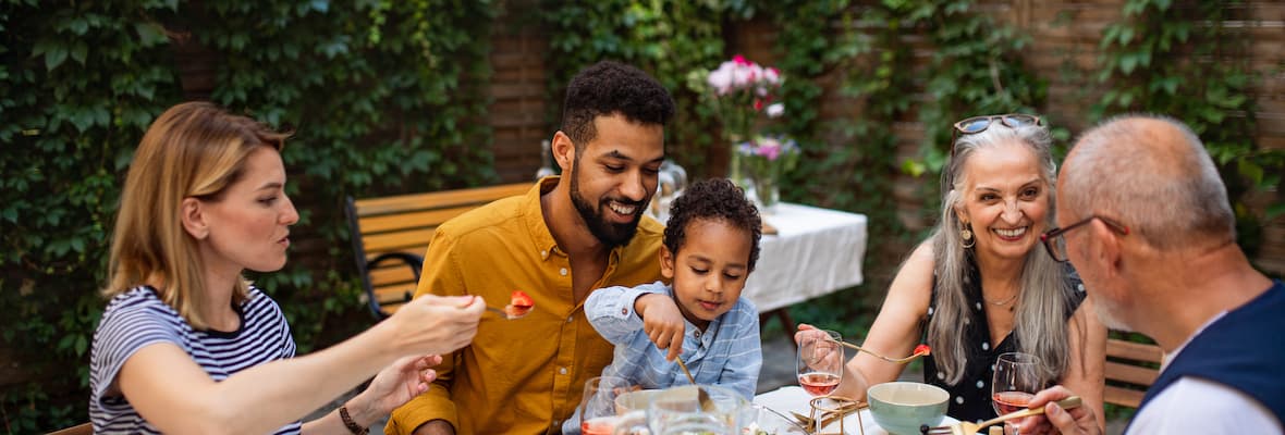 Happy family gathering around table to eat together