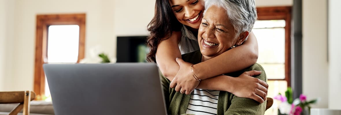 Smiling woman hugs her grandmother